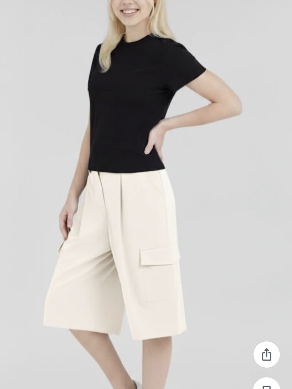 Mango white cargo-style trousers featuring wide legs and side flap pockets.